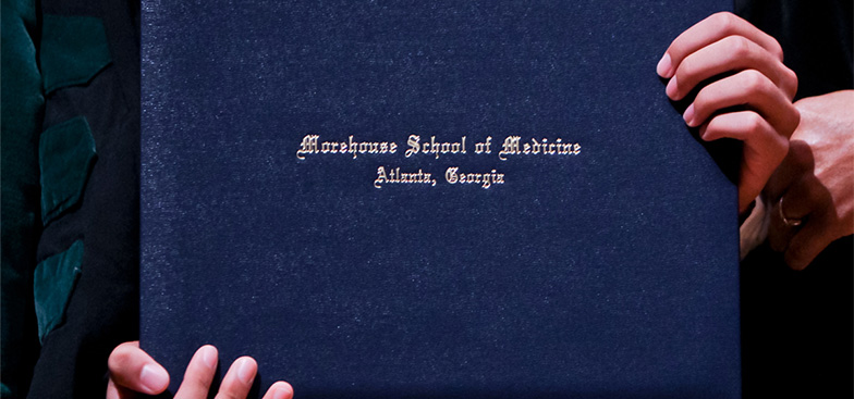 graduate holding diploma